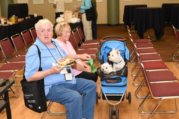 two people sitting in chairs, eating